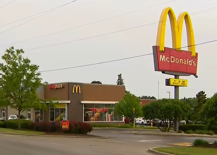 McDonald's exterior with large golden arches sign, related to story of lesbian attacked over bathroom use.