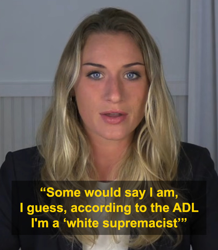 Woman with long blonde hair speaking in a video, overlay text referencing white supremacist and trad-wife influencer defense. Woman with long blonde hair speaking in a video, overlay text referencing white supremacist and trad-wife influencer defense.