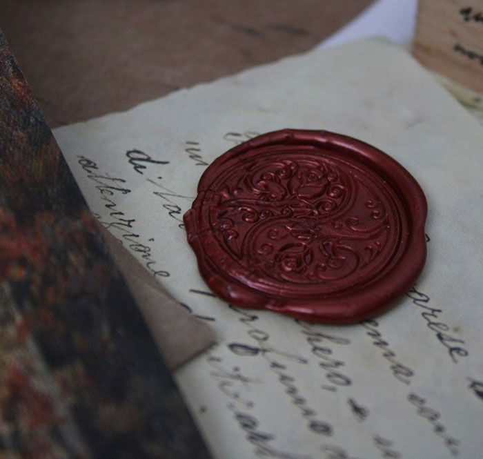 A close-up of an old letter sealed with red wax symbolizing secrecy and anonymity on the internet.
