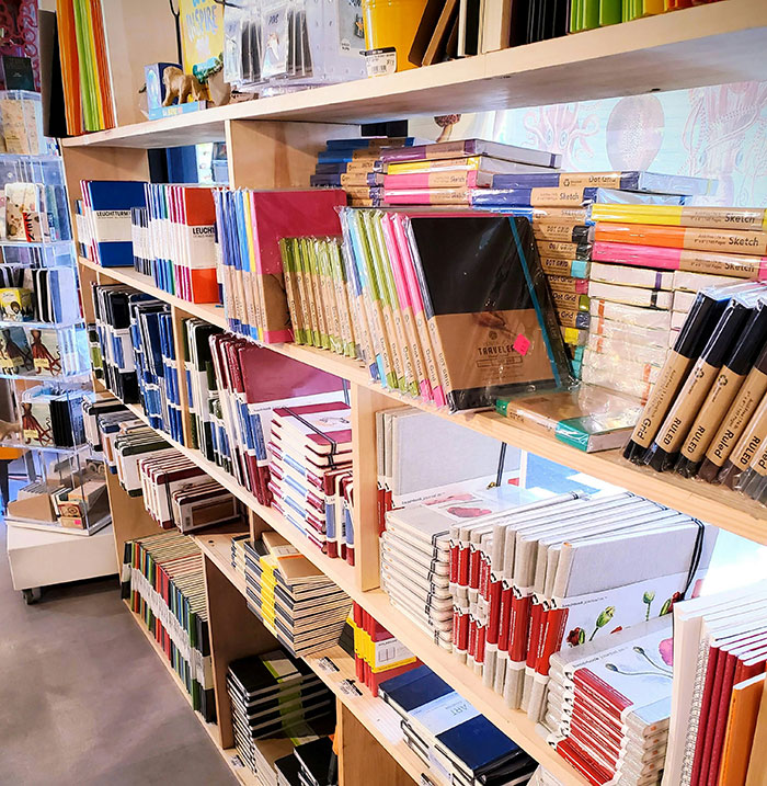 Shelves filled with notebooks and journals symbolizing how people use internet anonymity to share secrets privately.