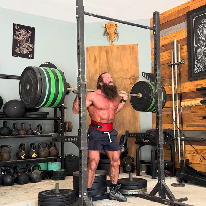 Muscular man lifting heavy weights in gym, highlighting the raw animal diet controversy surrounding Liver King. Muscular man lifting heavy weights in gym, highlighting the raw animal diet controversy surrounding Liver King.