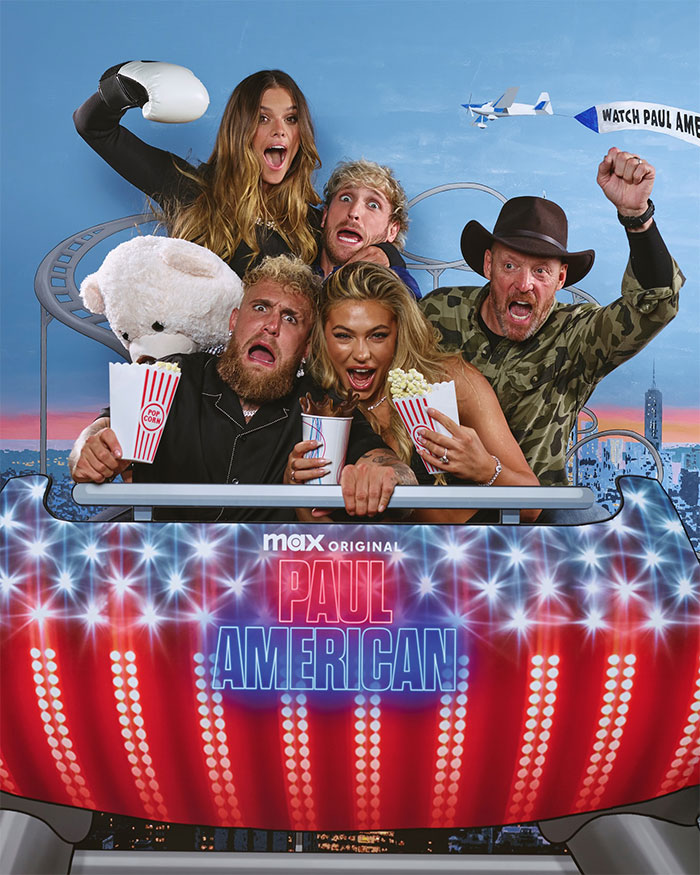 Group of people including Logan Paul posing excitedly in a roller coaster car with popcorn, related to Logan Paul net worth after prime discussion.