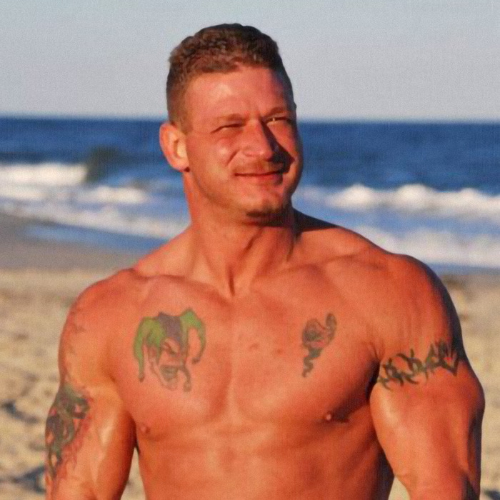 Muscular man with tattoos at the beach, relating to dad fatally beaten with metal bat news story.