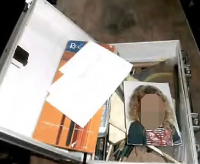 Photo of a metal case containing documents and a blurred image related to Madeleine McCann suspect investigation.