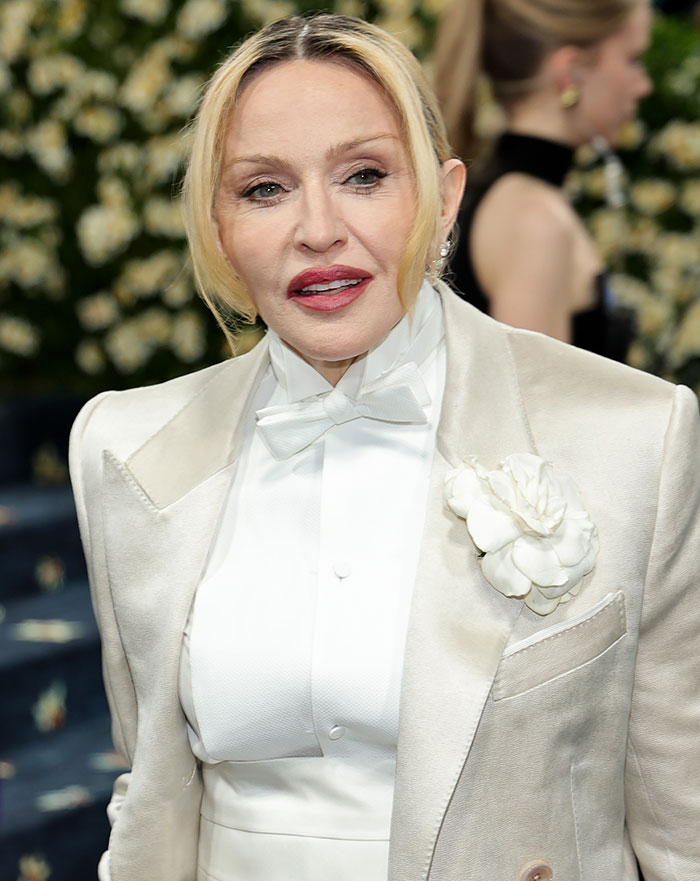 Madonna wearing a white suit with flower detail, fans notice a famous feature from her face is missing.