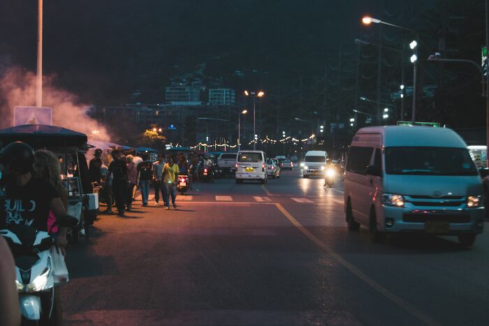 Nighttime street scene with people and vehicles, highlighting a major event happening today not covered by mainstream media.