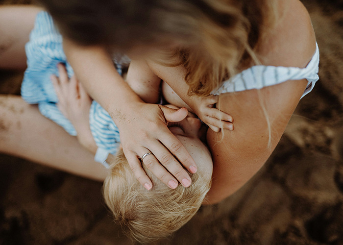 Medical workers showing calmness while holding a child, capturing genuine emotions in an unbelievable moment.