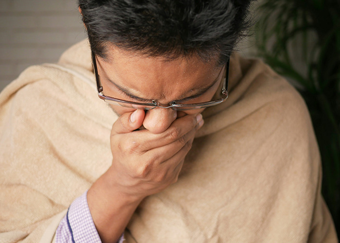 Medical worker pretending to be calm while covering mouth in shock, experiencing an unbelievable moment at work.