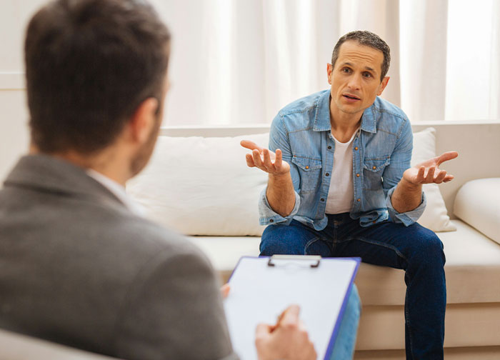 Patient expressing frustration during consultation with doctor, highlighting hurtful things said by doctors affecting trust.
