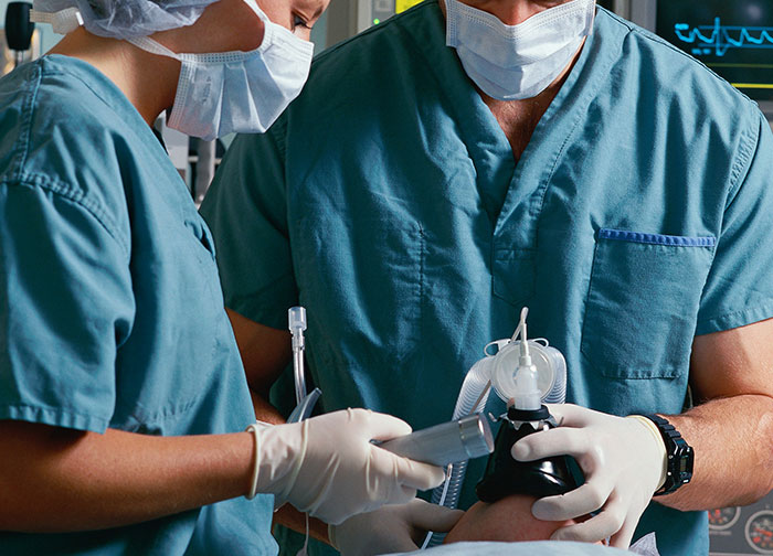 Two doctors in scrubs and masks preparing medical equipment highlighting hurtful things doctors said and did to patients.