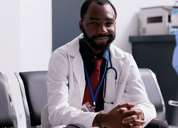 Male doctor in white coat and stethoscope sitting in clinic illustrating hurtful things doctors said to patients