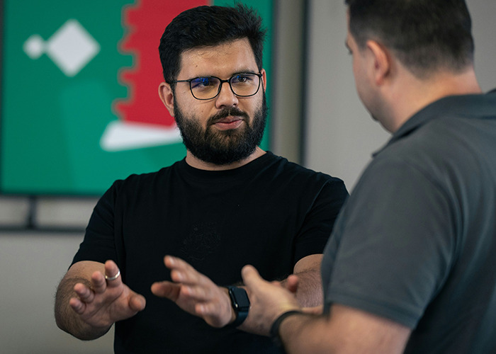 Two medical field employees engaged in a serious discussion in a professional indoor setting.