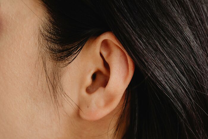 Close-up of a person's ear highlighting unique body features discussed by netizens, including diverse physical traits.