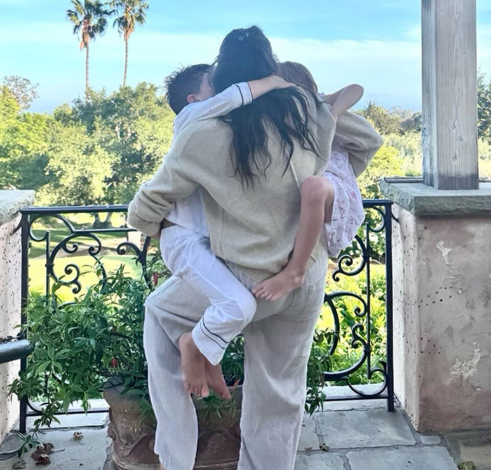 Meghan Markle embracing two children outdoors on a balcony with greenery, highlighting 3-year-old Lilibet’s face in a beekeeping clip Meghan Markle embracing two children outdoors on a balcony with greenery, highlighting 3-year-old Lilibet’s face in a beekeeping clip