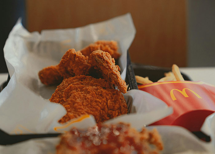 Fried chicken and fries from a fast food meal, highlighting concerns about kids being fed unhealthy fast food.