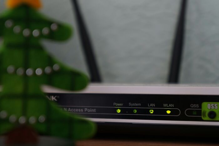 Close-up of a wireless router with status lights on, illustrating mind-boggling beliefs about smart technology use online.