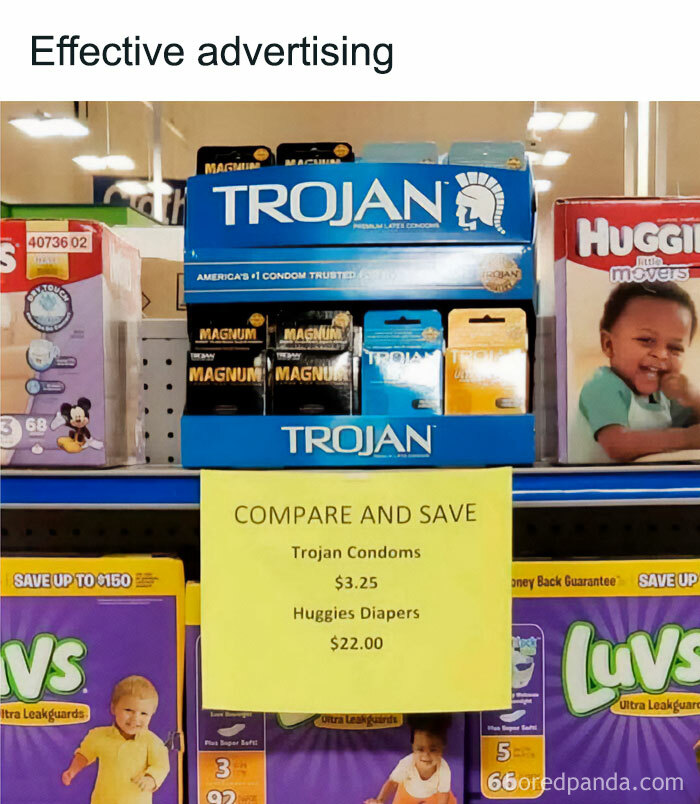 Grocery store shelf showing condoms next to diapers with a sign highlighting price difference in a mocking posts jokes memes style.