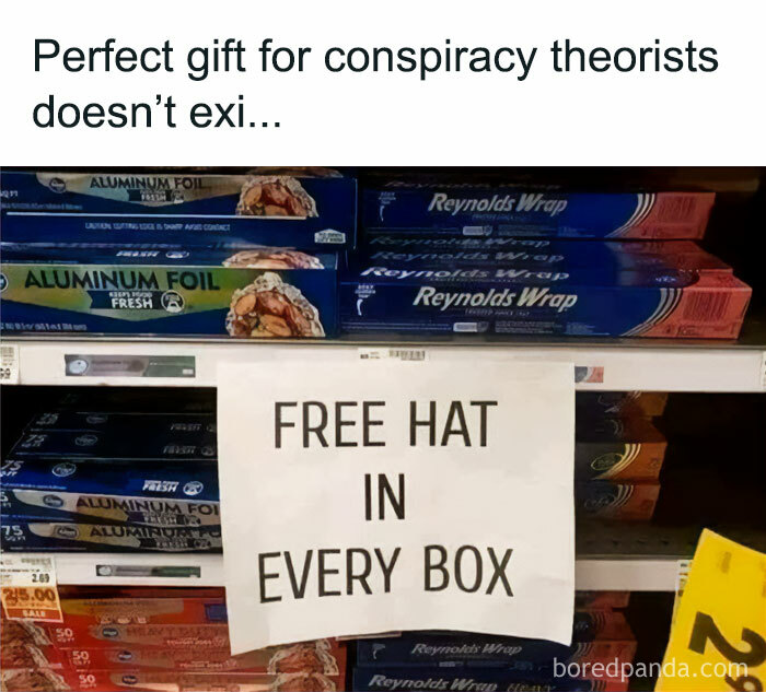 Sign on store shelf of aluminum foil boxes humorously claims a free hat in every box, mocking posts jokes memes.