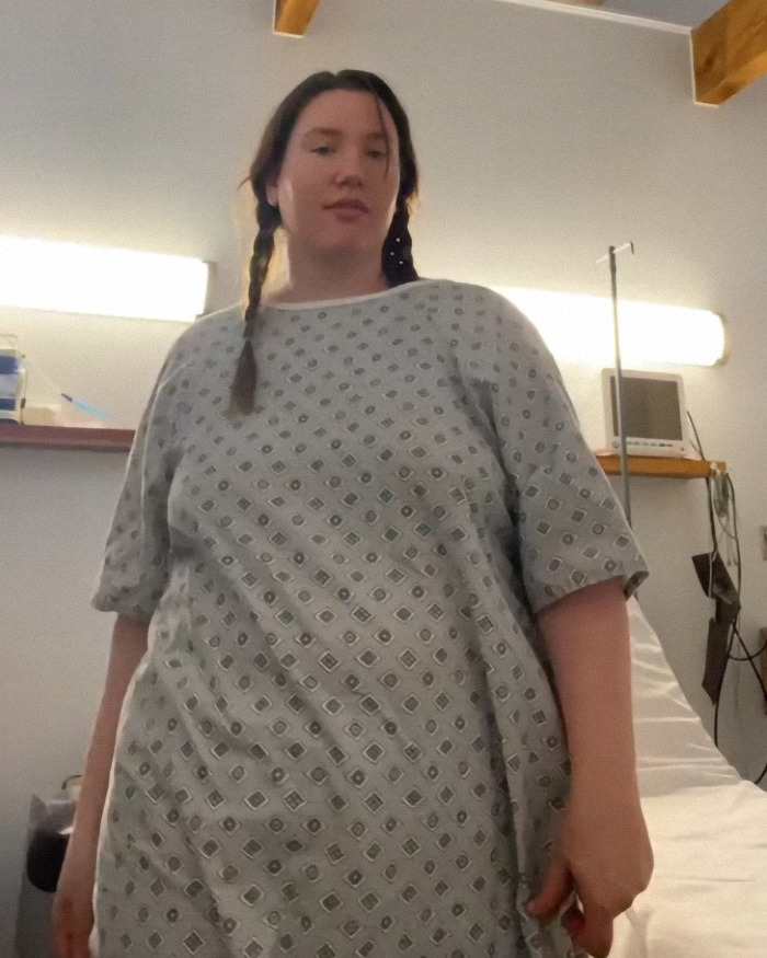 Mom wakes from surgery in hospital gown, looking surprised and unprepared for how many kids she gave birth to.