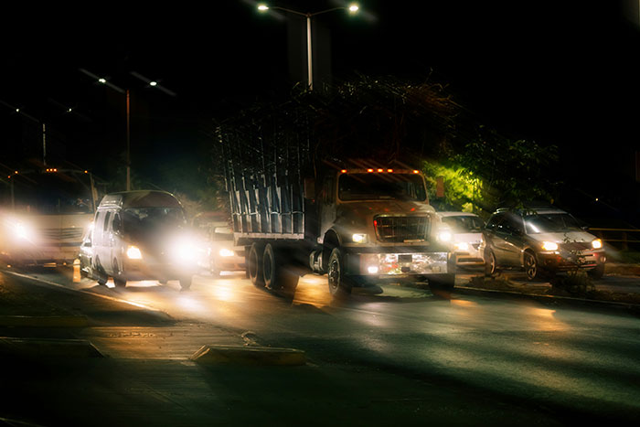 Nighttime street scene with cars and trucks, emphasizing real-life stories of instinct during late night strolls.