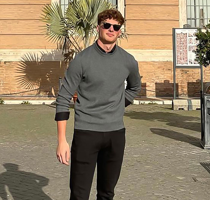 Man wearing sunglasses and a grey sweater outdoors, capturing the massive thirst over guy in Lana Del Rey Met Gala photo.