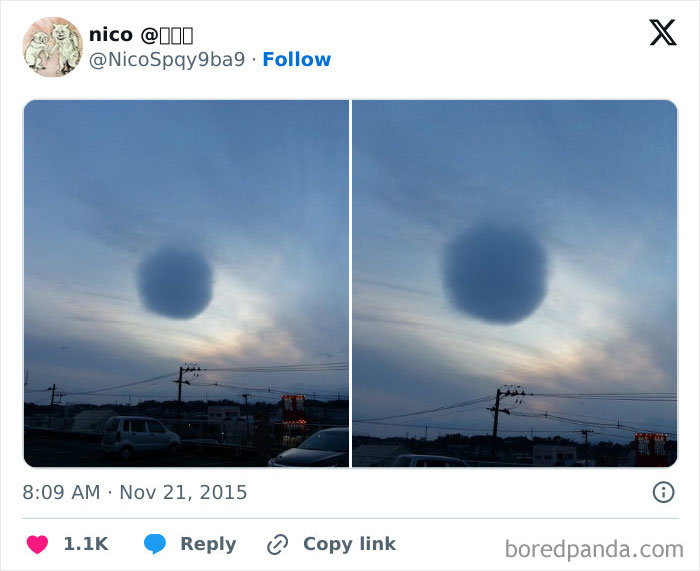 Dark circular cloud formation in the sky over a cityscape showcasing rare natural phenomena at dusk.