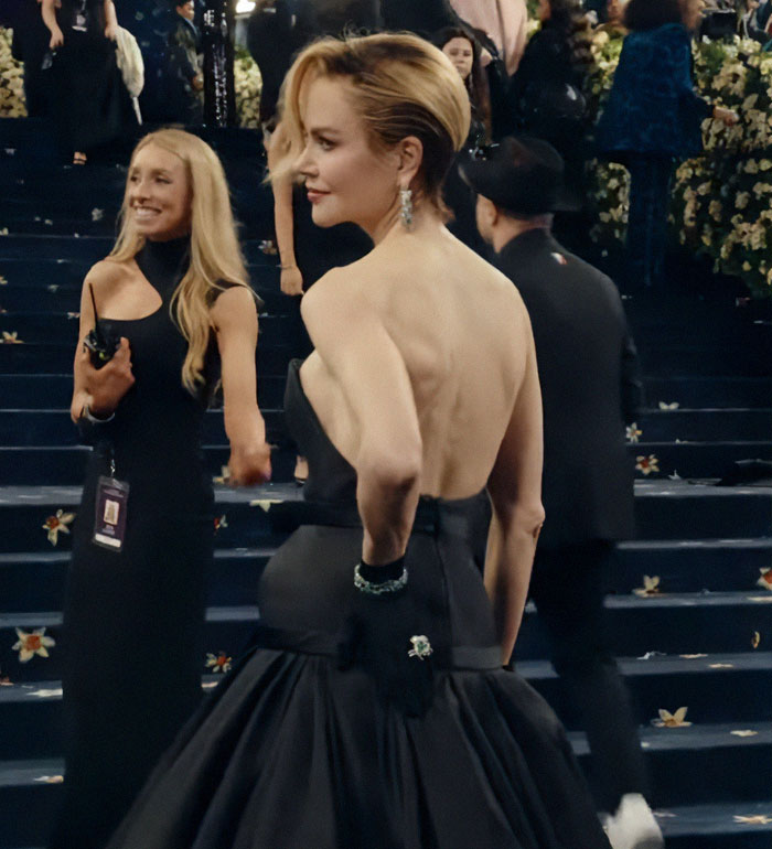 Nicole Kidman on the red carpet at Cannes revealing a wig topper mishap in an elegant black gown.