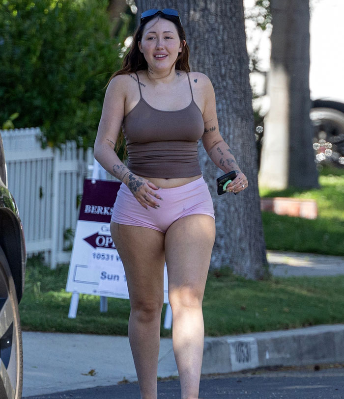Noah Cyrus wearing a revealing outfit while walking outdoors, attracting attention after her Hannah Montana post.