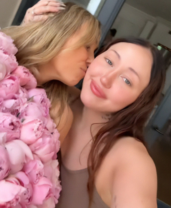 Noah Cyrus with a revealing look posing closely as she shares a post related to Hannah Montana controversy.