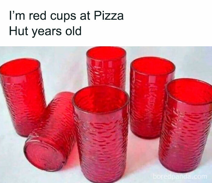Six textured red plastic cups arranged on a white surface, evoking nostalgic memories of Pizza Hut days.