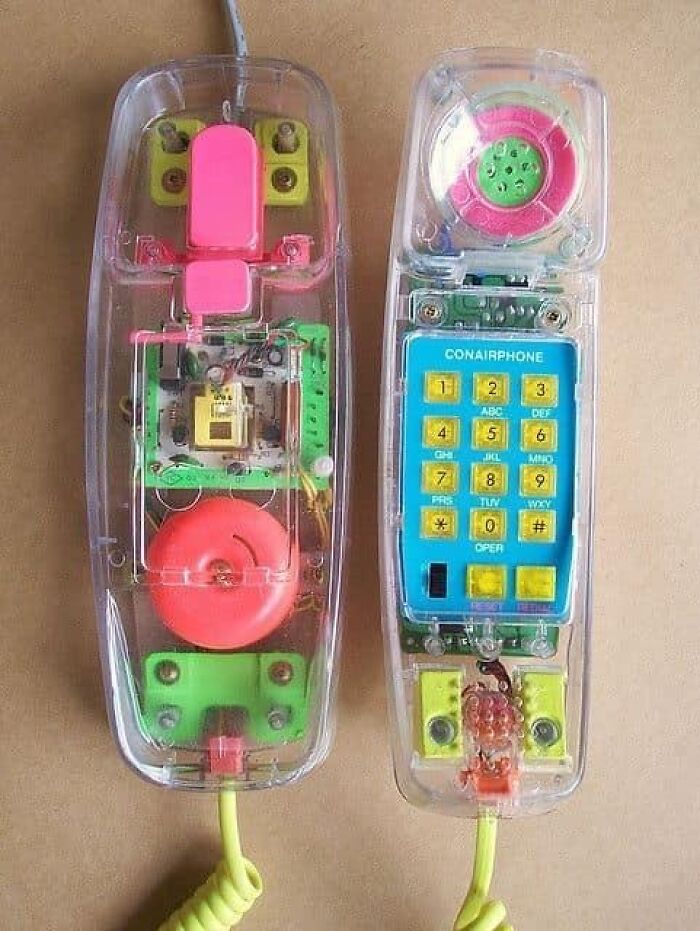 Clear plastic landline phone with colorful internal components visible, a popular cringey nineties fashion accessory.