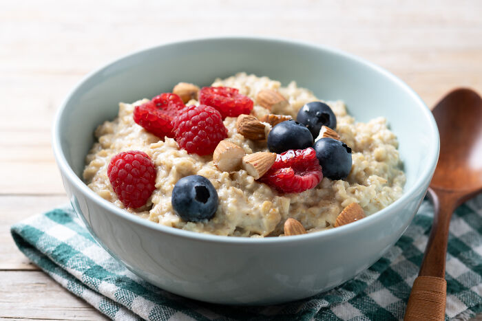Bowl of oatmeal topped with fresh berries and almonds, illustrating wild cooking opinions and creative food ideas.