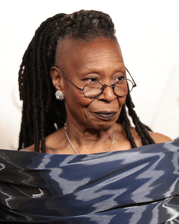 Woman with glasses and braided hair wearing a patterned blue shawl, representing discussions about Ozempic mouth side effects. Woman with glasses and braided hair wearing a patterned blue shawl, representing discussions about Ozempic mouth side effects.