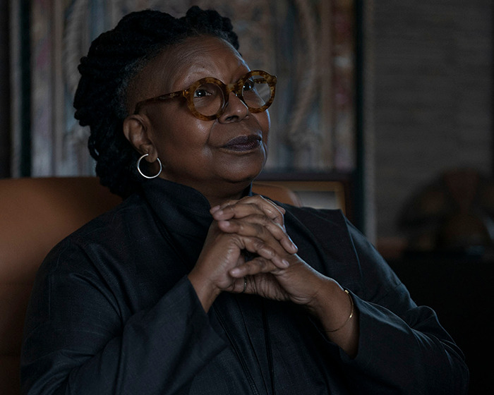 Middle-aged woman wearing glasses and dark clothing, sitting thoughtfully in a dimly lit room, discussing Ozempic mouth side effects. Middle-aged woman wearing glasses and dark clothing, sitting thoughtfully in a dimly lit room, discussing Ozempic mouth side effects.