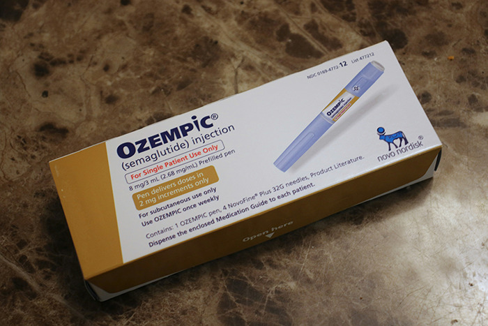 Ozempic injection pen box on marble surface for weight loss and diabetes management medication. Ozempic injection pen box on marble surface for weight loss and diabetes management medication.