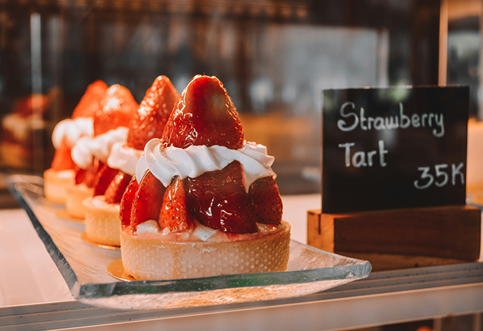 Strawberry tart dessert with fresh strawberries and cream, highlighting a partner upset over strawberry allergy.