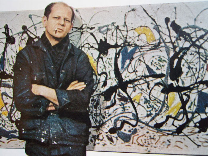 Man with arms crossed standing in front of abstract art, illustrating Steve Jobs and celebrities praised after passing.