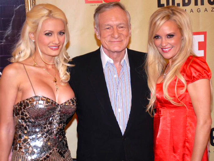 Three people posing at an event, showcasing celebrities often praised posthumously like Steve Jobs in life and legacy discussions.