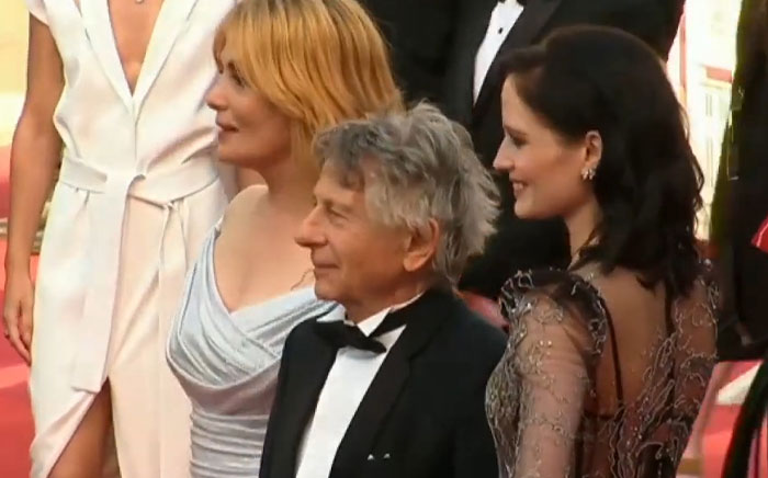 Group of celebrities posing on red carpet at an event, showcasing glamorous fashion and elegant attire, Steve Jobs topic.