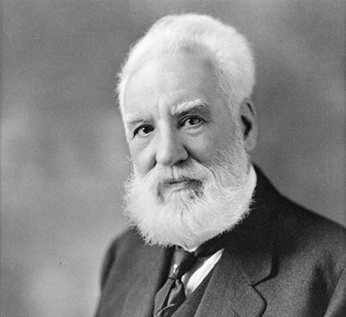 Black and white portrait of an elderly man with a white beard and suit, representing notable historical celebrities.
