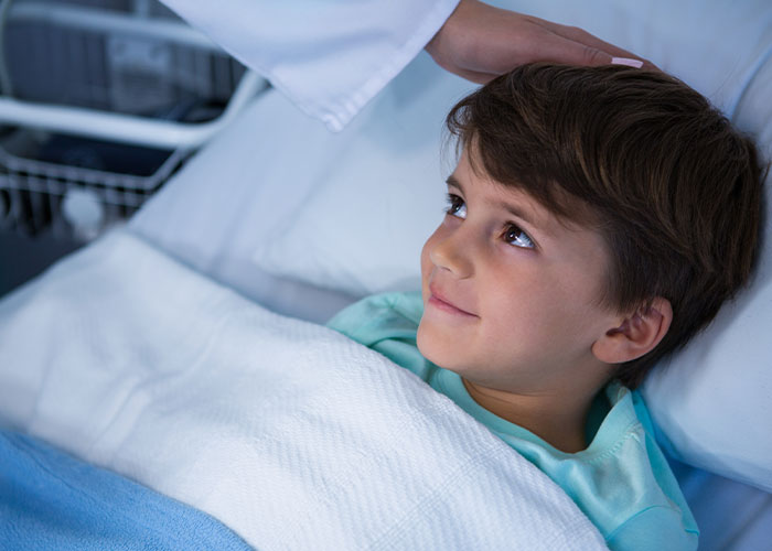 Young patient lying in hospital bed gently comforted by a doctor, illustrating chilling final words from dying patients.