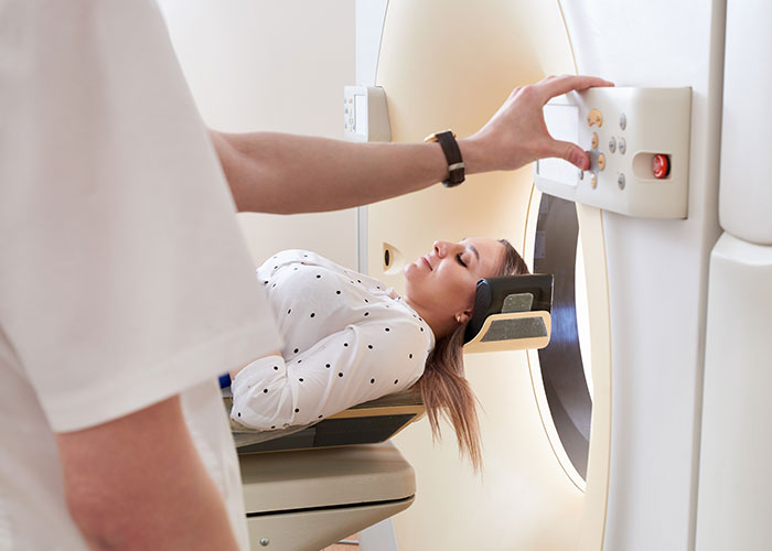 Patient undergoing CT scan in hospital, highlighting risks when a patient's lie nearly costs their life.