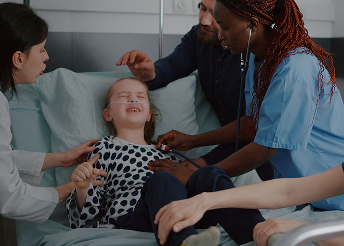 Medical team examining a child patient in hospital bed, highlighting risks when a patient’s lie affects medical care.