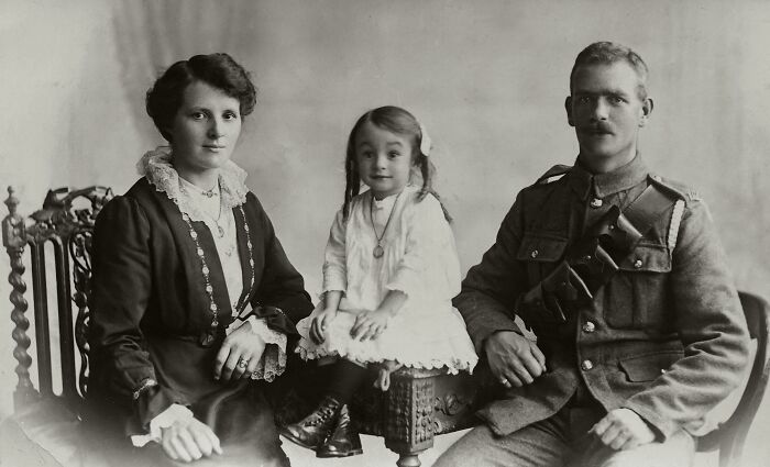 Vintage family portrait with a soldier, mother, and child, illustrating things folks only romanticize without experience.