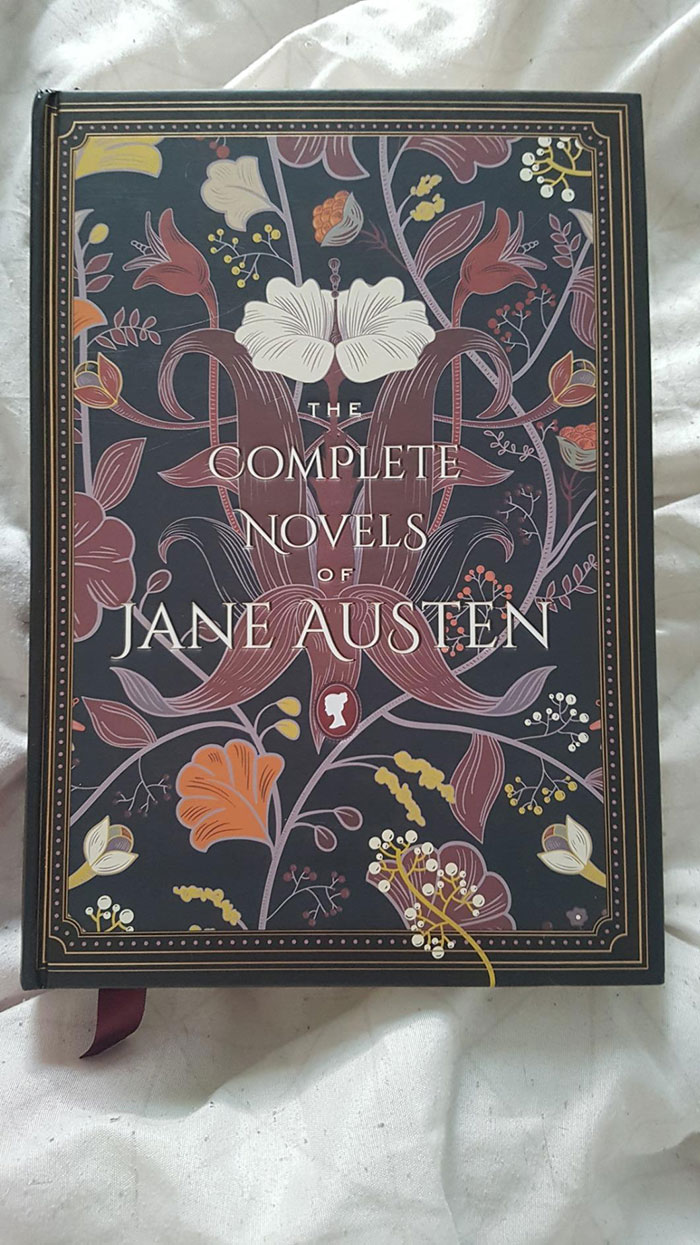 Hardcover edition of classic literature book complete novels of Jane Austen with floral decorative cover design.