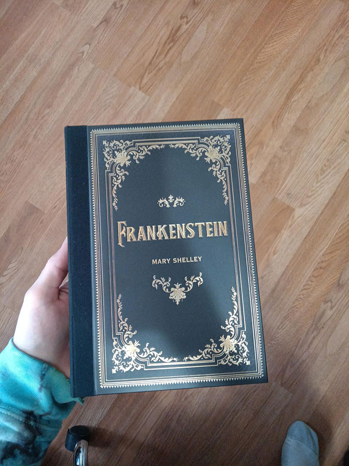 Hand holding a classic edition of Frankenstein by Mary Shelley, one of the excellent books recommended by readers online.