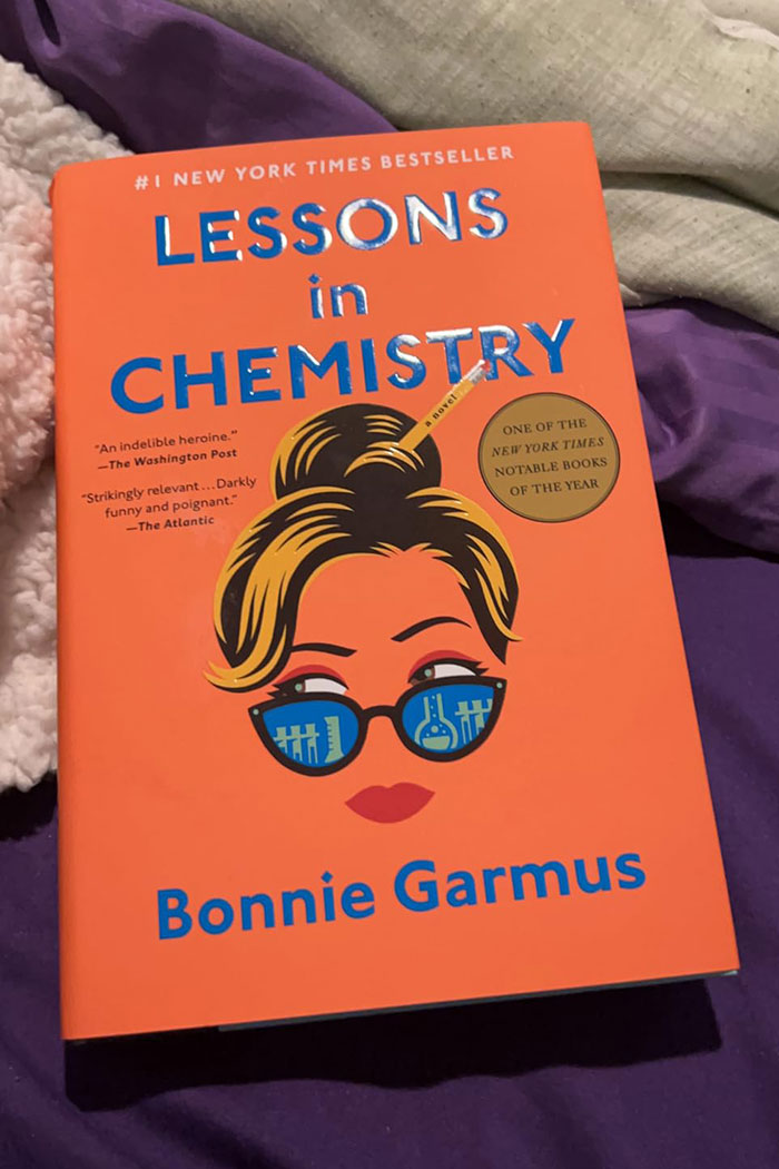 Bright orange book cover of Lessons in Chemistry by Bonnie Garmus, recommended in excellent books by readers online.