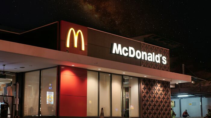 McDonald's restaurant at night under a starry sky, illustrating a casual setting for disturbing confessions.