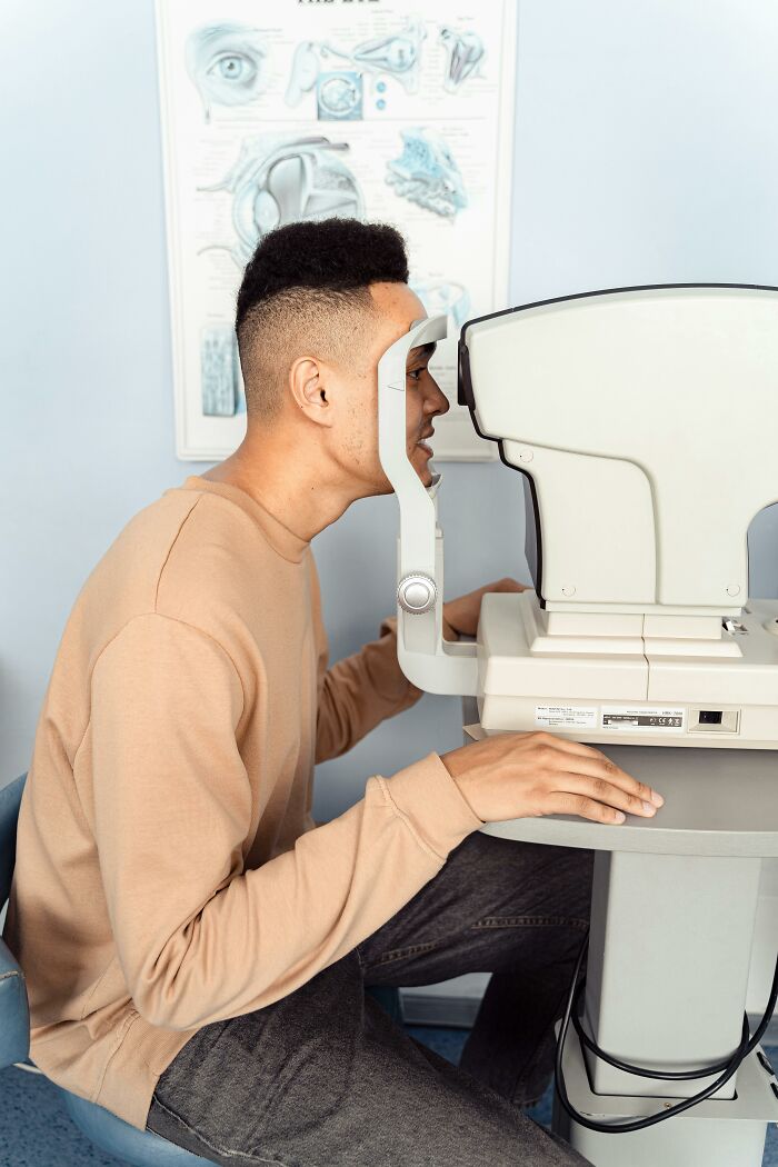 Man undergoing eye exam in a clinic, highlighting concerns related to tinnitus on a daily basis and body health risks.