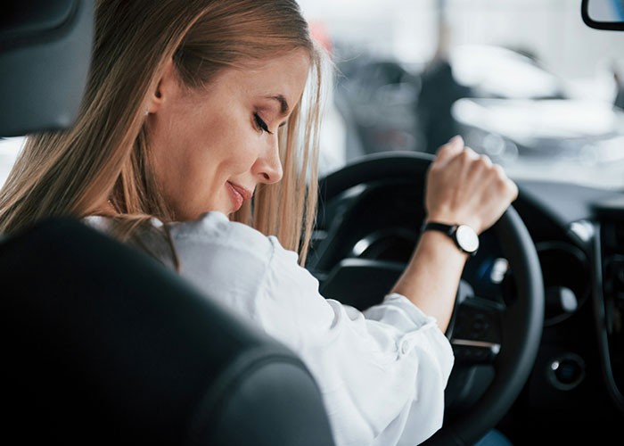 Young woman in car showing confident expression after exposing cheating partner, highlighting infidelity and betrayal themes.